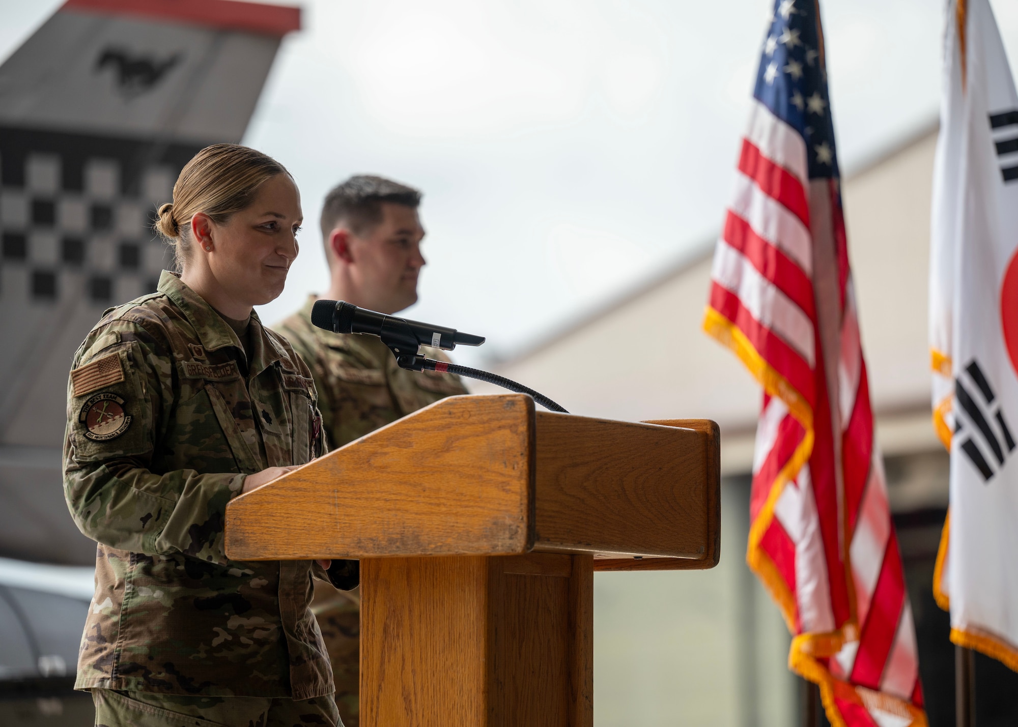 U.S. Air Force Lt. Col. Evin Greensfelder, outgoing 51st Maintenance Squadron commander, delivers farewell remarks during a Change of Command ceremony at Osan Air Base, Republic of Korea, July 2, 2025. As commander, Greensfelder led over 420 Airmen and civilian personnel across backshop sections and 16 Air Force specialty codes. (U.S. Air Force photo by Staff Sgt. Sarah Williams)