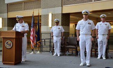 Captain Ken Radford is pictured reading his orders as he positions to take command at Navy Medicine Readiness and Training Command (NMRTC) Patuxent River. NMRTC Patuxent River's change of command ceremony took place on June 27, 2025, as Captain Jeremy Hawker relinquished command to Radford. The ceremony marked the transition of leadership for the command which encompasses NMRTC Patuxent River, Navy Medicine and Readiness Training Unit (NMRTU) Dahlgren, NMRTC Detachment Indian Head, and NMRTC Detachment Joint Base Andrews. These locations provide essential medical support to over 90 tenant commands across the region. The Commanding Officer of NMRTC Patuxent River also serves as the Director for Naval Health Clinic Patuxent River and its branch clinics.