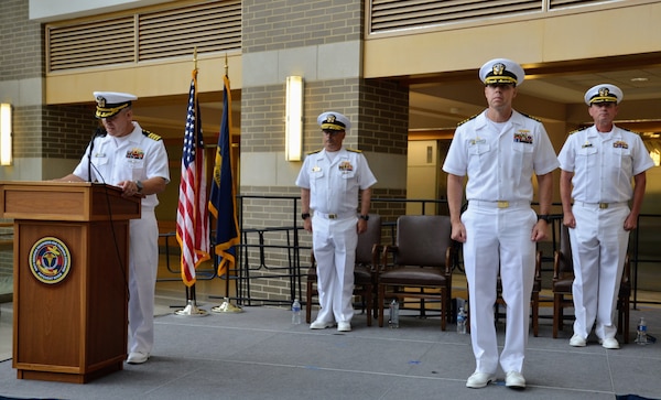 Captain Ken Radford is pictured reading his orders as he positions to take command at Navy Medicine Readiness and Training Command (NMRTC) Patuxent River. NMRTC Patuxent River's change of command ceremony took place on June 27, 2025, as Captain Jeremy Hawker relinquished command to Radford. The ceremony marked the transition of leadership for the command which encompasses NMRTC Patuxent River, Navy Medicine and Readiness Training Unit (NMRTU) Dahlgren, NMRTC Detachment Indian Head, and NMRTC Detachment Joint Base Andrews. These locations provide essential medical support to over 90 tenant commands across the region. The Commanding Officer of NMRTC Patuxent River also serves as the Director for Naval Health Clinic Patuxent River and its branch clinics.