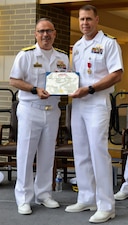 Rear Admiral Robert J. Hawkins, Commander of Naval Medical Forces Atlantic and Director, Defense Health Network (DHN) Atlantic in Portsmouth, Virginia, held authority over the change of command at Navy Medicine Readiness and Training Command Patuxent River. Hawkins presents Captain Jeremy J. Hawker with the Legion of Merit Award in recognition of Hawker's exceptionally meritorious conduct in the performance of outstanding services and achievements.