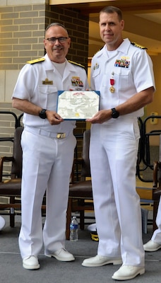 Rear Admiral Robert J. Hawkins, Commander of Naval Medical Forces Atlantic and Director, Defense Health Network (DHN) Atlantic in Portsmouth, Virginia, held authority over the change of command at Navy Medicine Readiness and Training Command Patuxent River. Hawkins presents Captain Jeremy J. Hawker with the Legion of Merit Award in recognition of Hawker's exceptionally meritorious conduct in the performance of outstanding services and achievements.