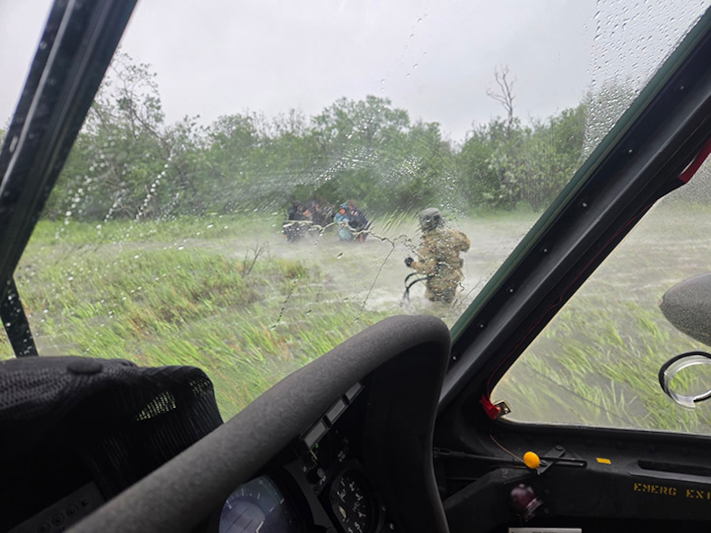Alaska Army National Guard Chief Warrant Officer 3 Nick Lime, an aviator assigned to 207th Aviation Battalion, assists six distressed people stranded on the Kuskokwim River during a rescue mission June 30, 2025.