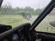 Alaska Army National Guard Chief Warrant Officer 3 Nick Lime, an aviator assigned to 207th Aviation Battalion, assists six distressed people stranded on the Kuskokwim River during a rescue mission June 30, 2025.