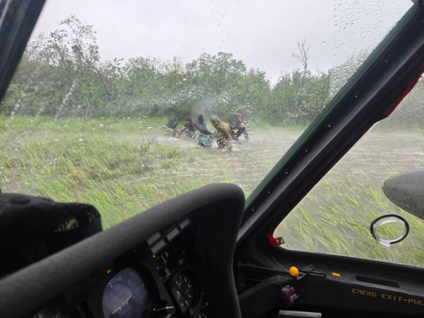 Alaska Army National Guard Chief Warrant Officer 3 Nick Lime, an aviator assigned to 207th Aviation Battalion, assists six distressed people stranded on the Kuskokwim River during a rescue mission June 30, 2025.