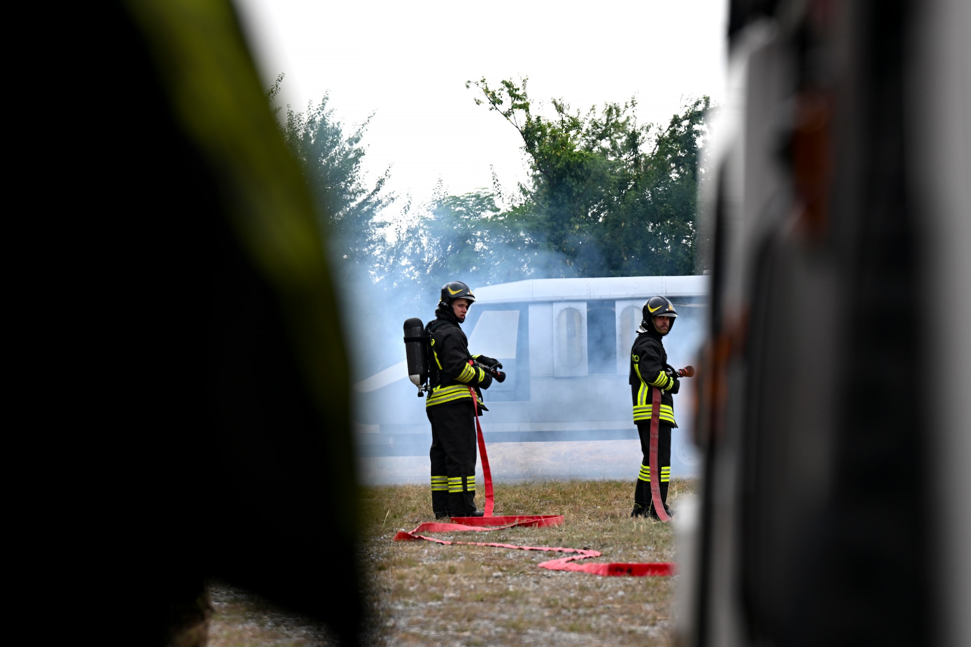 Italian firefighters holds a fire hose.