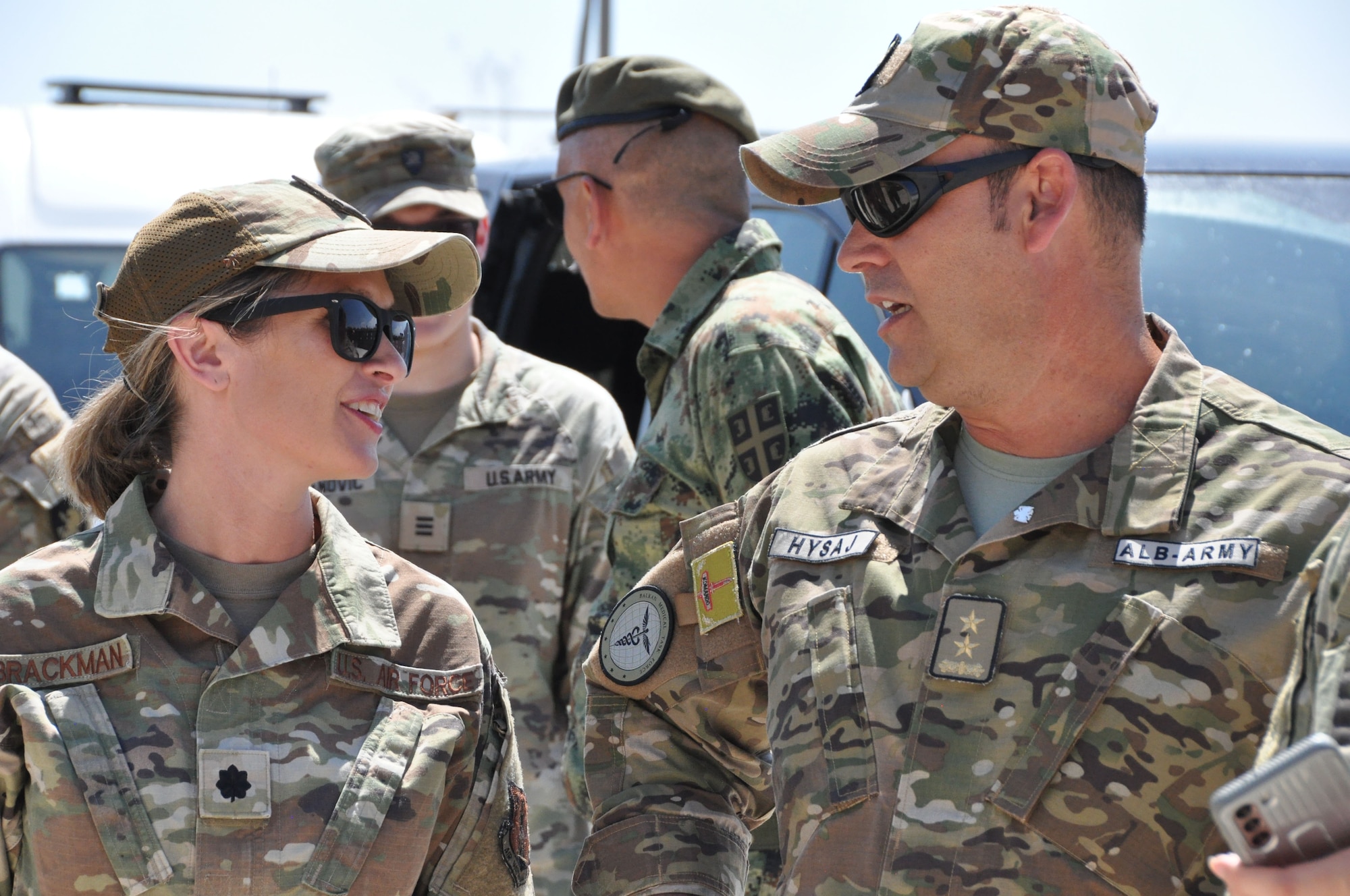 A group of service members talking.