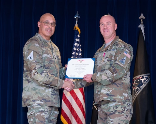  U.S. Space Force Lt. Gen. David N. Miller, Jr. presents the Legion of Merit to U.S. Space Force Col. Andrew Menschner, outgoing Mission Delta 31 (MD 31) commander, at a Change of Command Ceremony at Peterson Space Force Base, Colo., June 27, 2025.