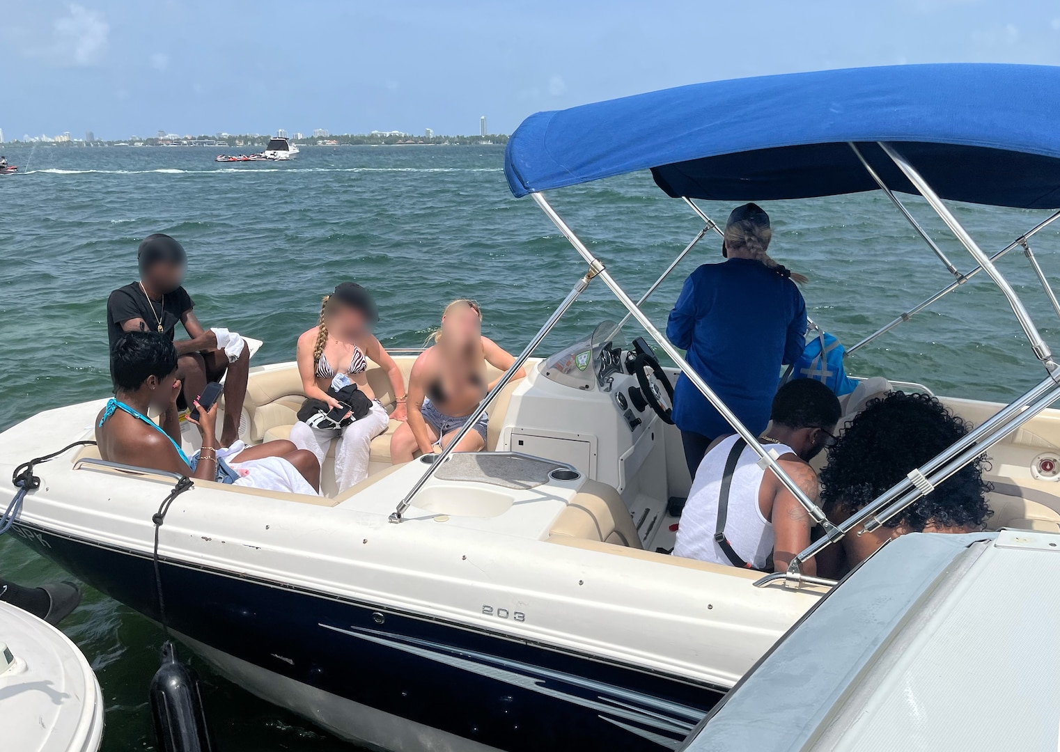 People sit on boat during a Coast Guard inspection