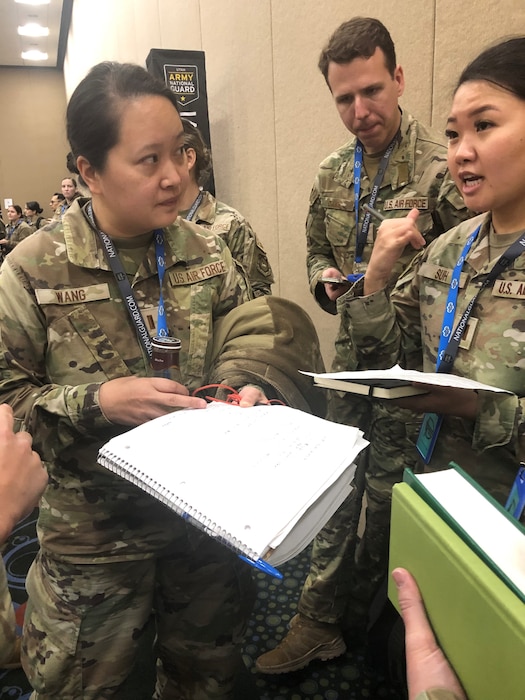 1st Lt. Xue Wang, Chinese Mandarin LEAP Scholar and System Engineering Manager, Wright-Patterson AFB, consults with fellow Language Enabled Airman Program Scholars during the 2024 Polyglot competition sponsored by the 300th Military Intelligence Brigade.  (Photo by Mr. Christopher R. Chesser)