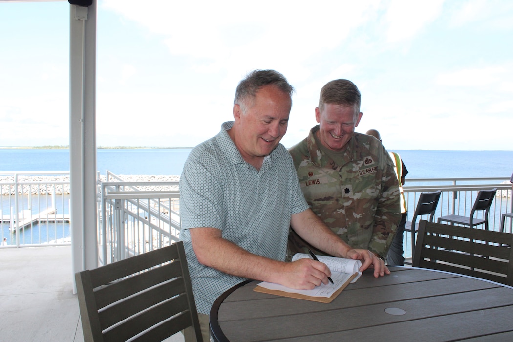 men sign document