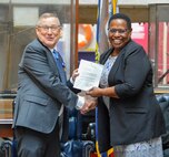 Steven Van Dyk, SSP's Chief Engineer, is presented a retirement letter from Juanita Christensen, Defense Contract Management Agency's technical directorate executive director. Through his efforts, Van Dyk established a strong relationship between DCMA and SSP.