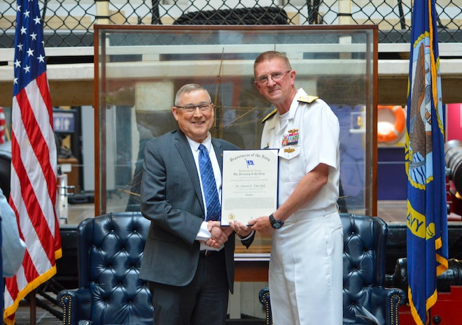 Steven Van Dyk, SSP's Chief Engineer, is presented with the Navy Distinguished Civilian Service award by Vice Adm. Johnny Wolfe, director of SSP.