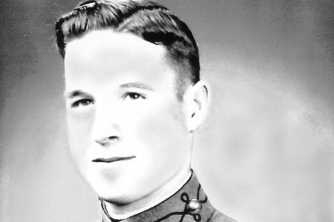 A man wearing a military uniform smiles for a photo.