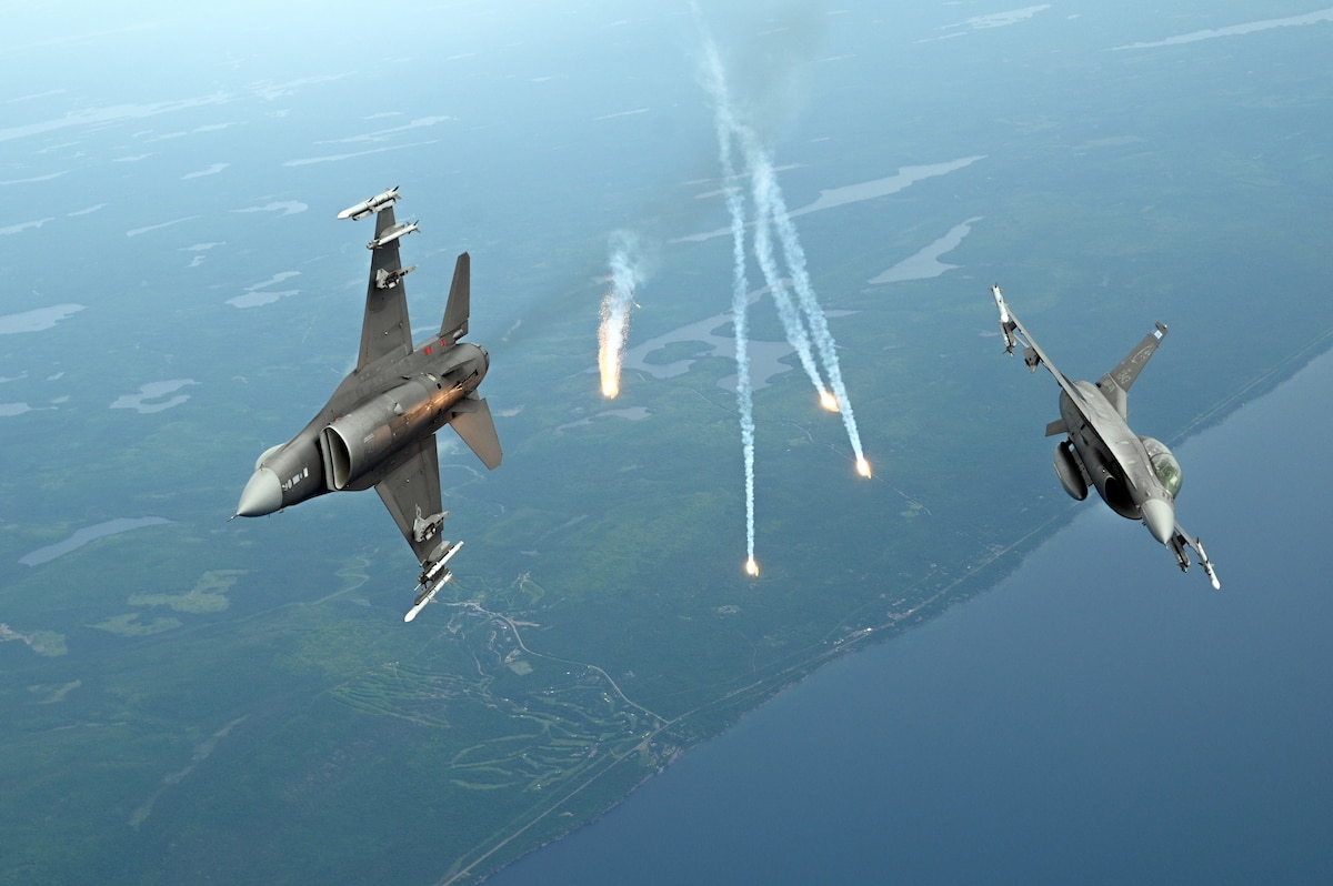 F-16 Fighting Falcons from the 148th Fighter Wing deploy flares over Duluth, Minn., June 26, 2025. The flares simulate combat conditions and improve pilots’ skills in managing threats. (U.S. Air National Guard photo by Senior Airman Addie Peterson)
