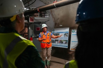 Lila Castellano, a Navy Closure Task Force-Red Hill (NCTF-RH) community liaison officer, speaks with visitors from the National Academies of Sciences, Engineering, and Medicine during a site visit to the Red Hill Bulk Fuel Storage Facility (RHBFSF) in Honolulu, June 24, 2025. Charged with the safe decommissioning of the facility, NCTF-RH was established by the Department of the Navy as a commitment to the community and the environment. NCTF-RH continues to engage with the people of Hawaii, regulatory agencies, and other stakeholders as it safely and deliberately decommissions the RHBFSF. (U.S. Navy photo by Mass Communication Specialist 1st Class Glenn Slaughter)