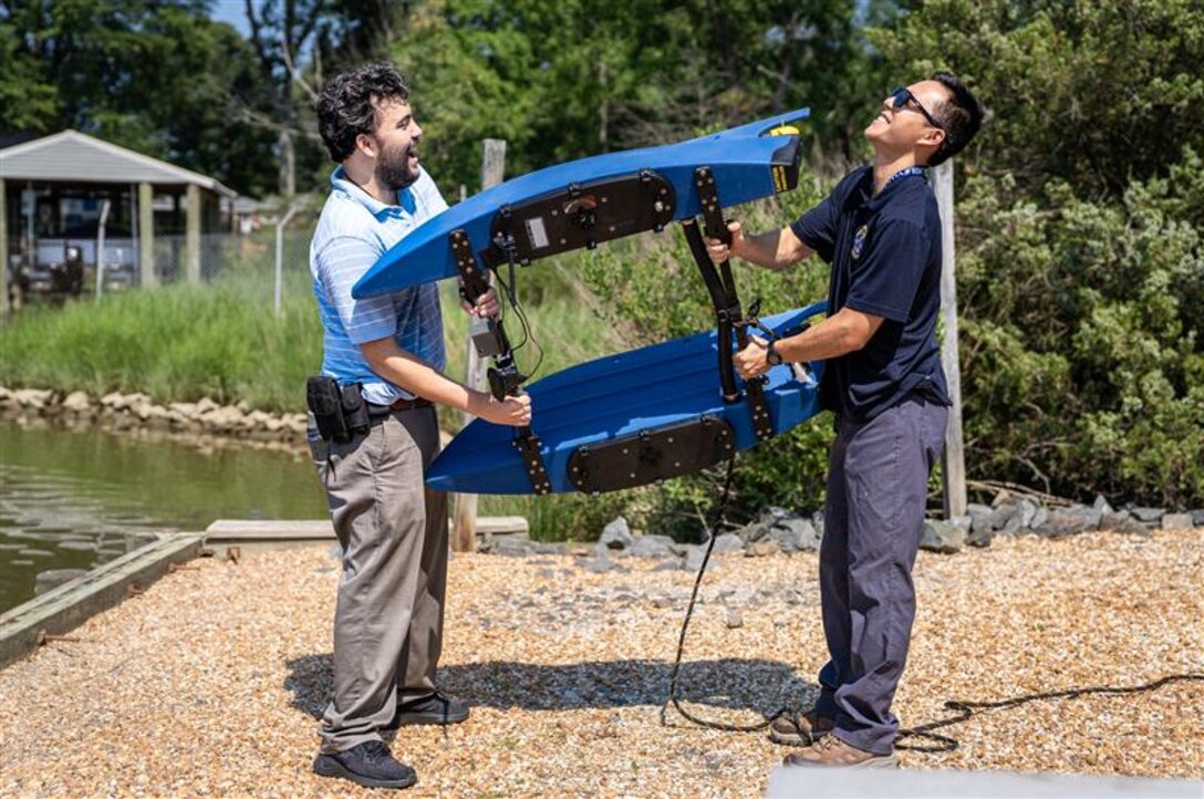 DAHLGREN, Va. – Cyber Engineer Alex Brown of Naval Surface Warfare Center Dahlgren Division (NSWCDD) Dam Neck Activity and NSWCDD engineer Roel Choi calibrate their team’s BlueBoat prior to launching. The two were participating alongside their team in a Workforce Development Innovation Challenge to develop a small, unmanned vessel with commercially available software and hardware to conduct autonomous intelligence, surveillance and reconnaissance missions on the water. (Dave Ellis/NSWCDD Photo)