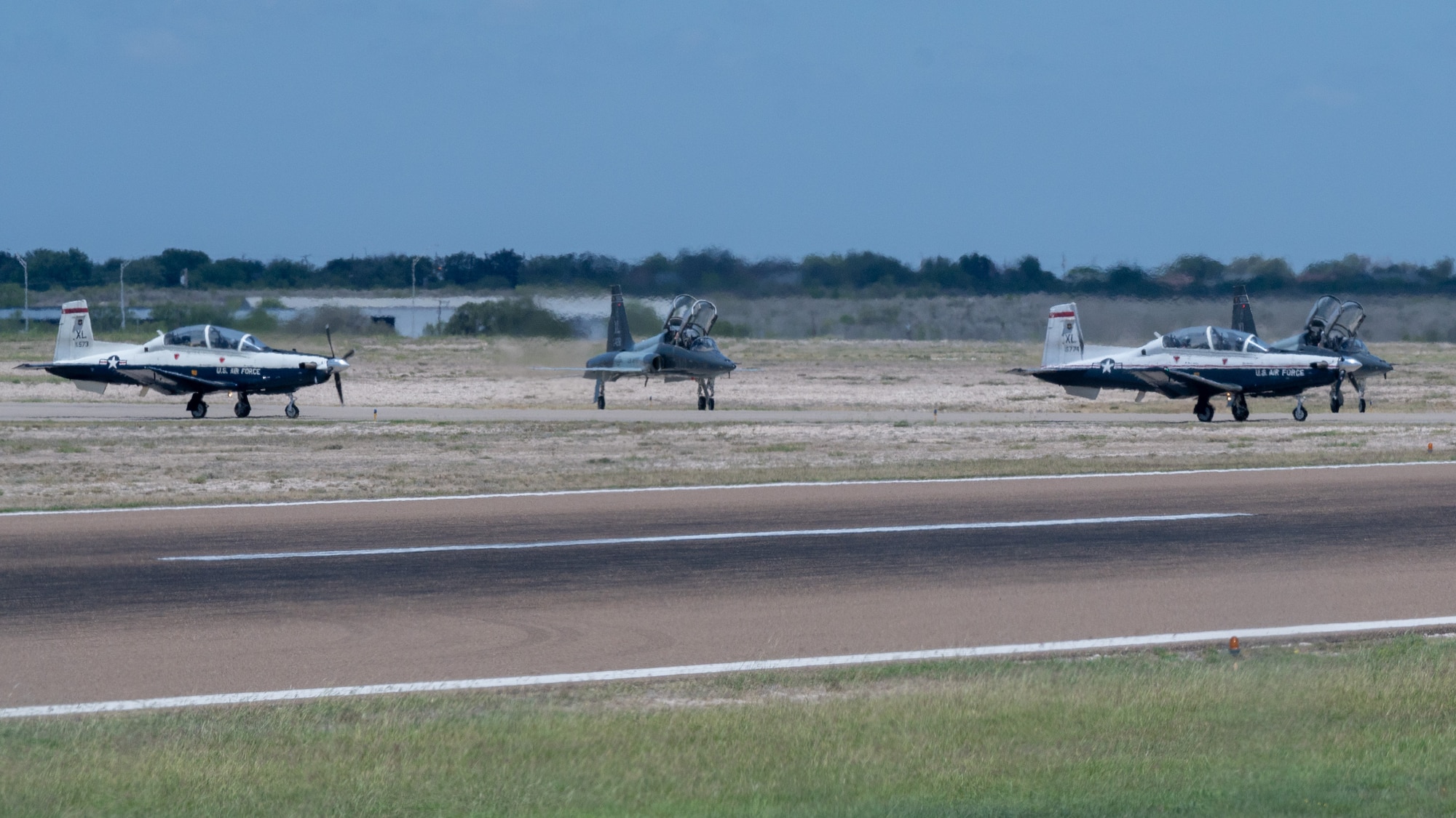 U.S. Air Force T-6A Texan II and T-38C Talon aircraft prepare to take off during an Uncontrolled Airfield Operations exercise at Laughlin Air Force Base, Texas, June, 26, 2025. The exercise simulated the tower being offline and unable to direct aircraft, forcing aircraft to rely on the Runway Supervisory Units to help ensure safety and operations. (U.S. Air Force photo by Staff Sgt. Nicholas Larsen)