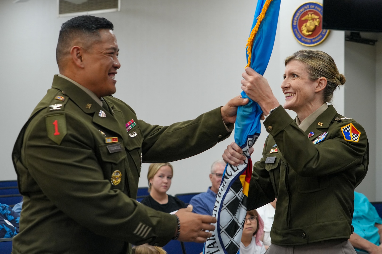 Army Col. Nicole Jepsen, USMEPCOM Eastern Sector commander, receives USMEPCOM Eastern Sector's colors from Col. Cochiaosue, USMEPCOM commander. USMEPCOM held an Assumption of Command ceremony for its Eastern Sector on June 2 in North Chicago, Ill.
