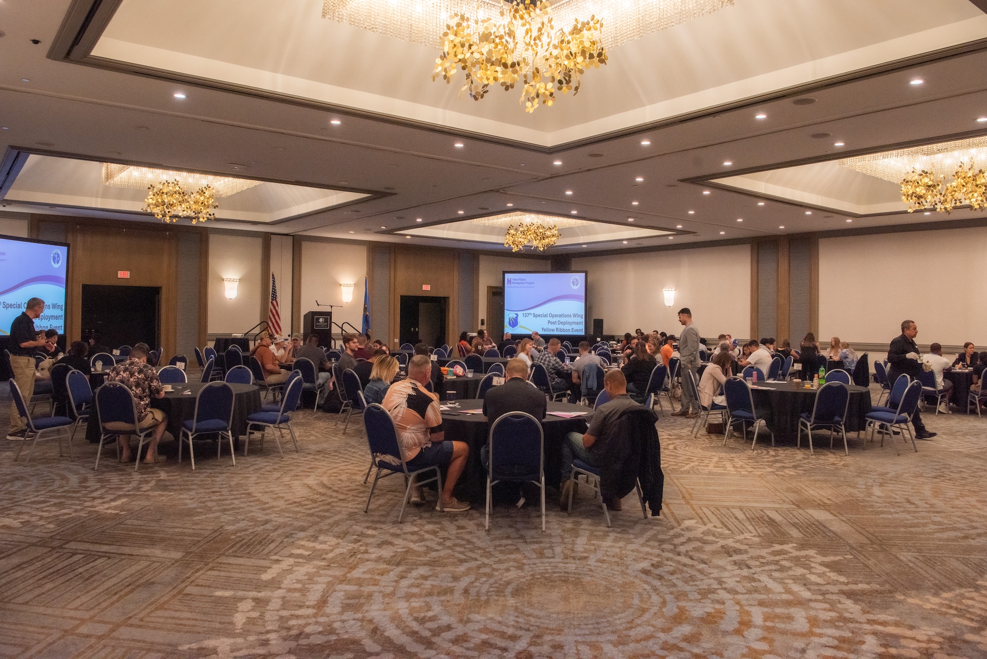 Attendees eat at tables in an open room.