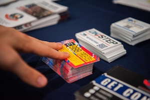 An attendee touches a 988 helpline card.