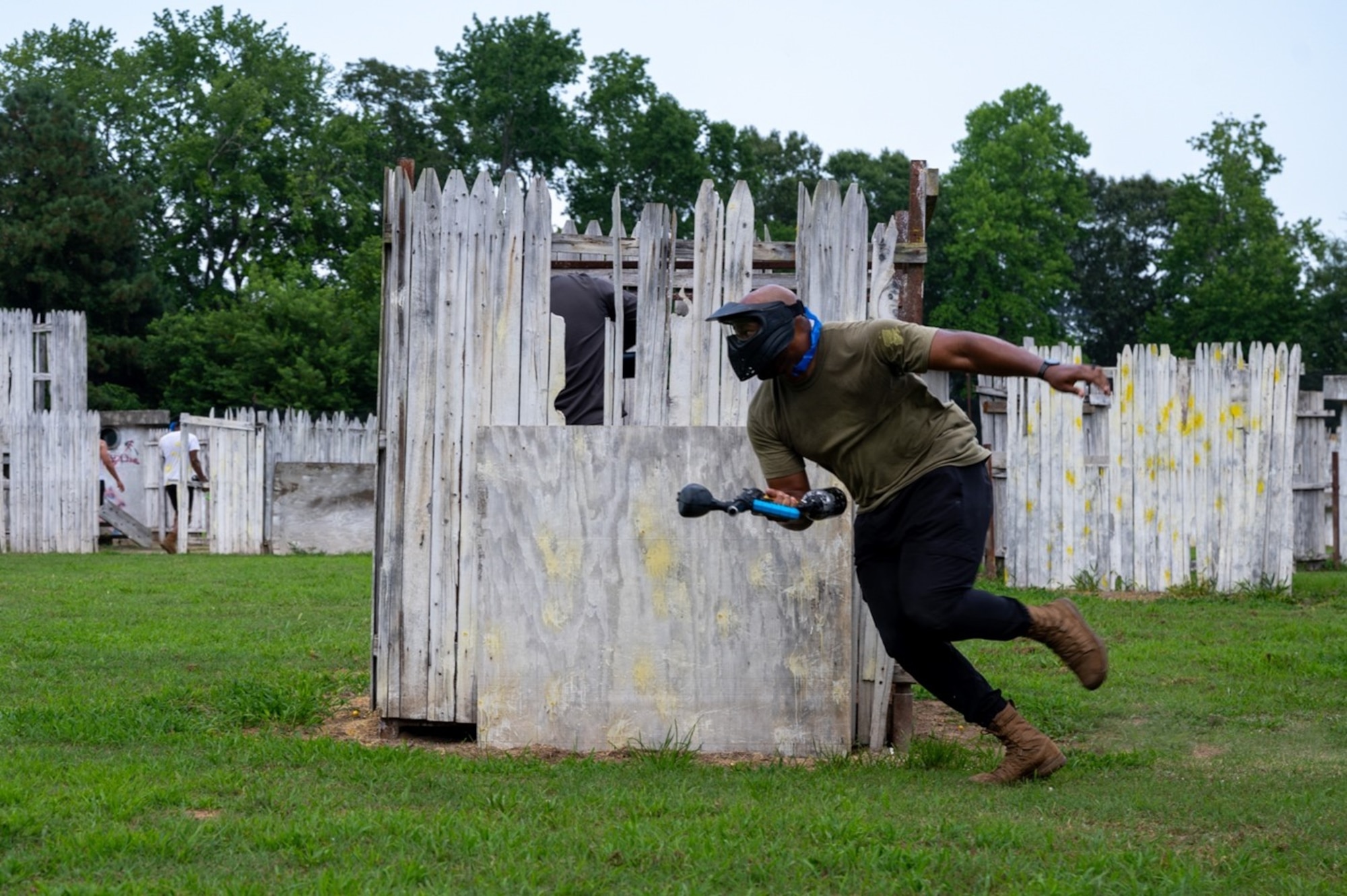 Airman runs across paintball field. (U.S. Air Force photo by Airman 1st Class Donnell Ramsey)