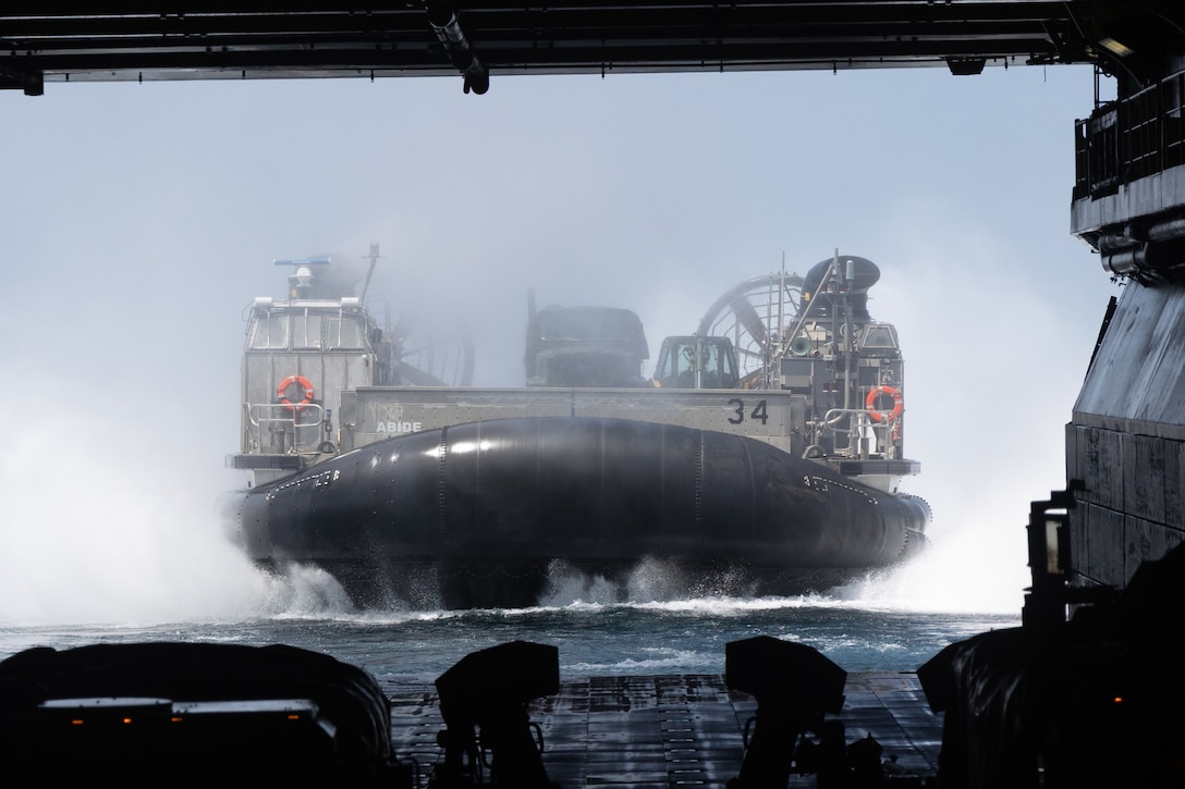 A U.S. Navy Landing Craft Air Cushion lands aboard the U.S. Navy Wasp-class amphibious assault ship USS Iwo Jima (LHD 7), during LCAC operations in support of Composite Training Unit Exercise while underway in the Atlantic Ocean, June 22, 2025. During COMPTUEX, the IWO ARG and 22nd MEU(SOC), refine tactics, techniques, and procedures to execute warfighting functions that enhance operational readiness and lethality as a unified IWOARG/22 MEU(SOC) team. (U.S. Marine Corps photo by Cpl. Sharon Errisuriz)