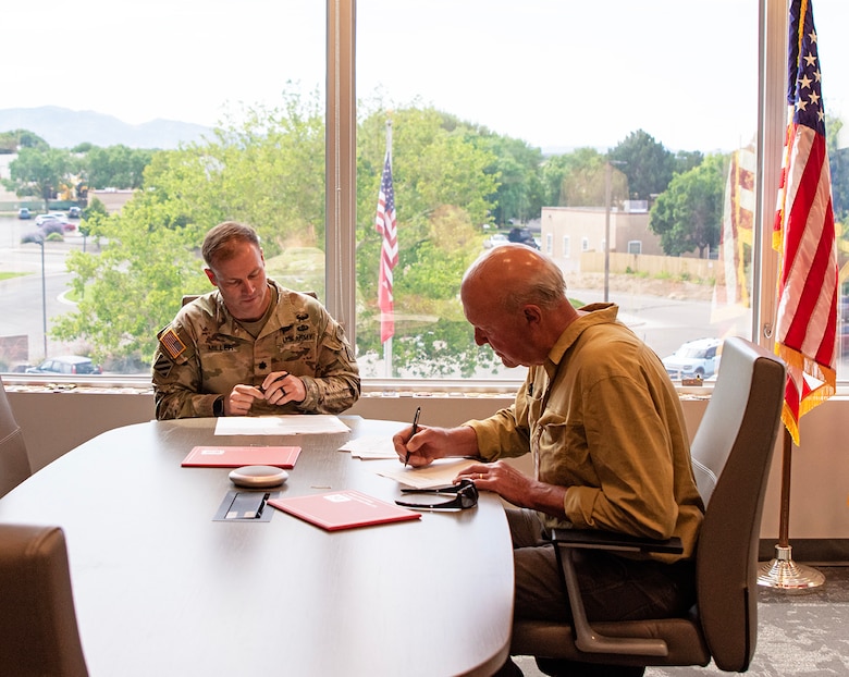 Lt. Col. Matthew Miller, left, commander, USACE-Albuquerque District, and Armand Groffman, vice president of the Regina, N.M., Mutual Domestic Water Consumers Association, sign an environmental infrastructure agreement at the Albuquerque District’s headquarters, June 27, 2025.