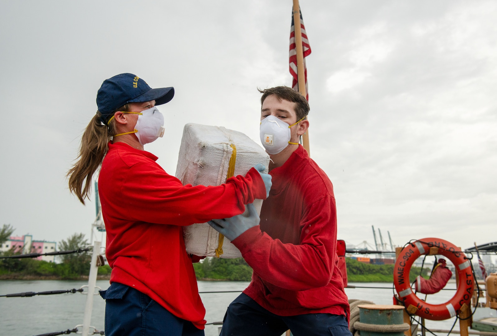 Coast Guard members offload illicit drugs