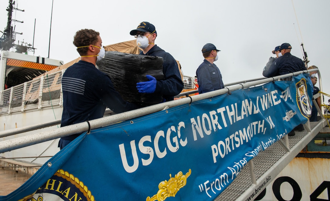 Coast Guard members offload illicit drugs
