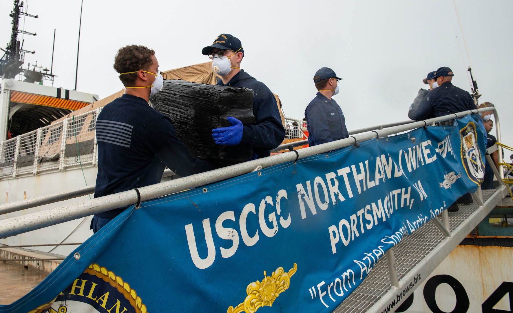 Coast Guard members offload illicit drugs