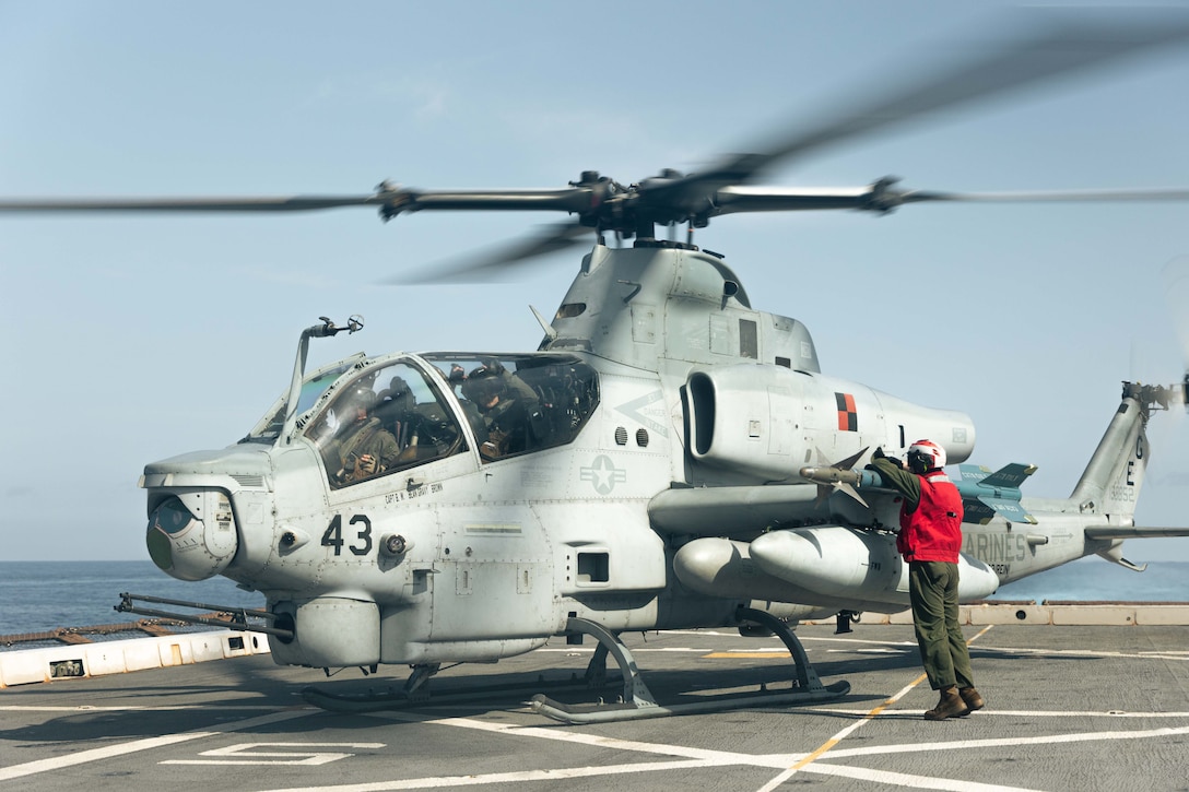 U.S. Marine Corps Lance Cpl. Robert Brunner, an aviation ordnance technician with Marine Medium Tiltrotor Squadron 263 (Reinforced), 22nd Marine Expeditionary Unit (Special Operations Capable), disarms an AH-1Z Cobra during Composite Training Unit Exercise aboard the San Antonio-class amphibious transport dock ship USS San Antonio (LPD 17), Iwo Jima Amphibious Ready Group, while underway in the Atlantic Ocean, June 26, 2025. During COMPTUEX, the IWOARG and 22nd MEU (SOC), refine tactics, techniques, and procedures to execute warfighting functions that enhance operational readiness and lethality as a unified IWOARG/22 MEU (SOC) team. (U.S. Marine Corps photo by Cpl. Maurion Moore)