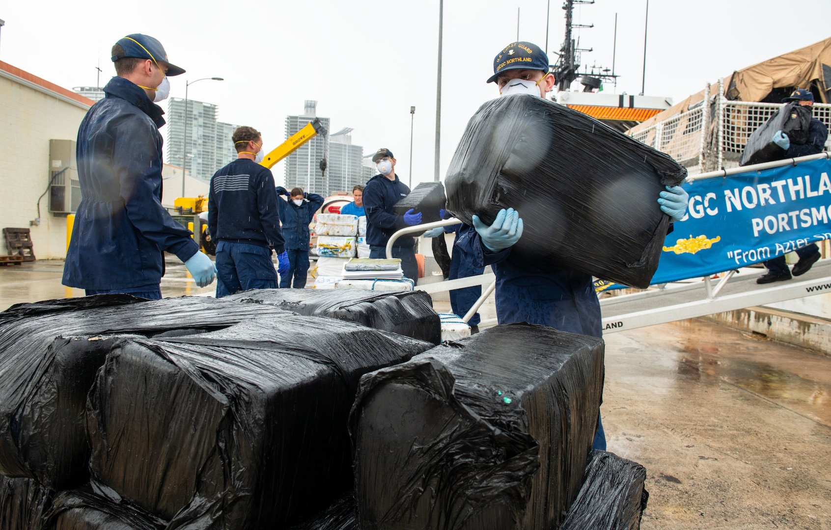 Coast Guard members offload illicit drugs