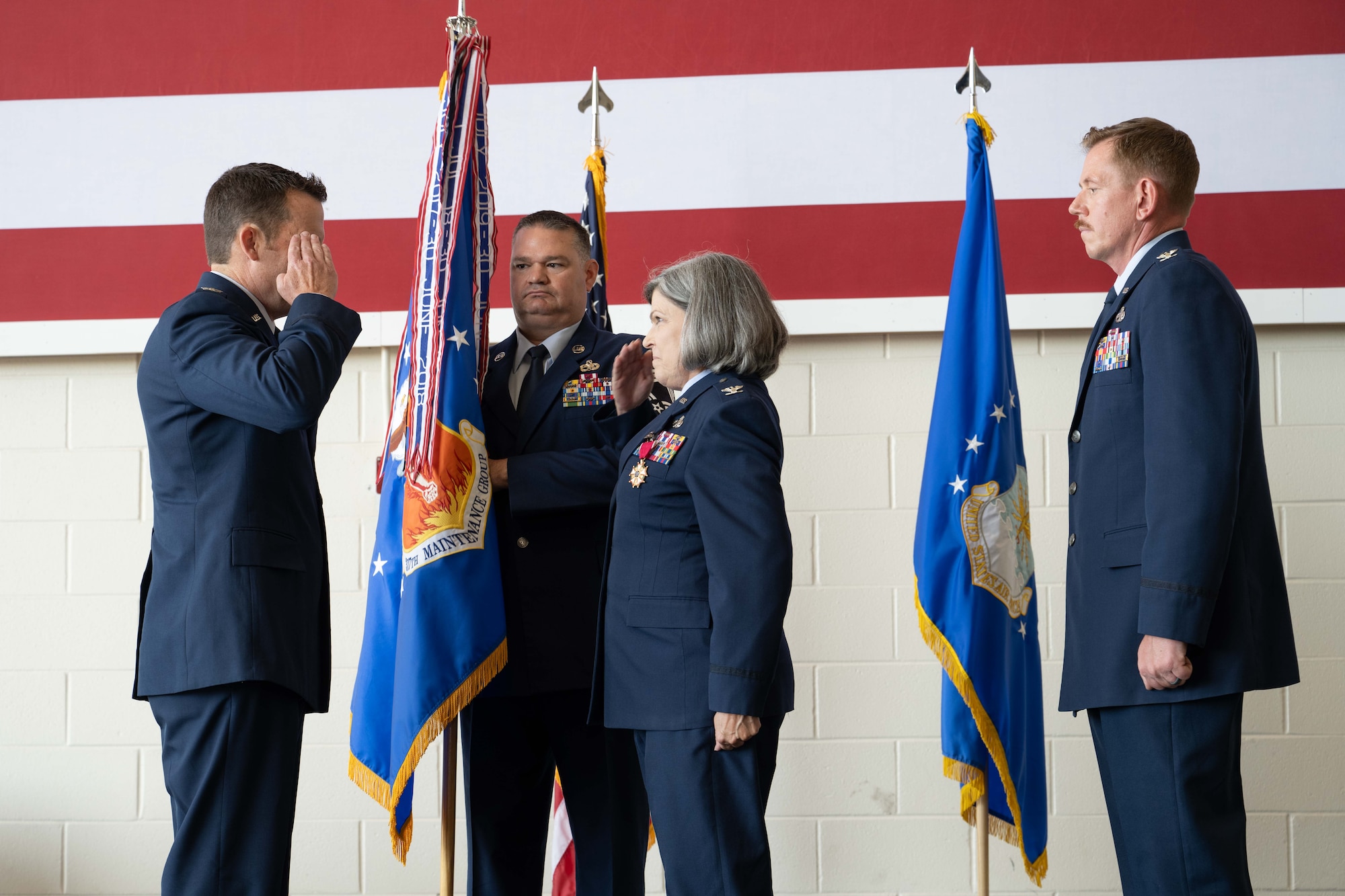 Col. Tiffany Feet, 317th Maintenance Group outgoing commander, relinquishes command of the 317th MXG during a change of command ceremony at Dyess Air Force Base, Texas, June 27, 2025. Col. Jason Purcell assumed command of the 317th MXG, responsible for keeping Dyess’ C-130J Super Hercules fleet fully mission capable. (U.S. Air Force photo by Airman Caleb Schellenberg)
