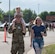 A family walks towards the festivities at Minot Air Force Base, North Dakota, June 27, 2025. Freedom Fest provided an opportunity for Airmen and their families to connect with the base community and support several local private organizations. (U.S. Air Force photo by Airman 1st Class Wesley Davies)