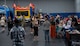 Airmen and their families gather to play and visit the booths of private organizations during Freedom Fest at Minot Air Force Base, North Dakota, June 27, 2025. Airmen and their families enjoyed an evening filled with meals from food vendors, music and a fireworks display that fostered a connection with the community. (U.S. Air Force photo by Airman 1st Class Wesley Davies)