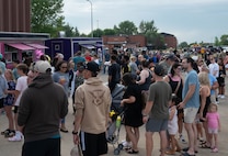 Airmen and their families gather at Freedom Fest for food and community at Minot Air Force Base, North Dakota, June 27, 2025. Airmen and their families enjoyed an evening filled with meals from food vendors, music and a fireworks display that fostered a connection with the community. (U.S. Air Force photo by Airman 1st Class Wesley Davies)