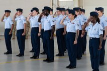 A photo of several Airmen saluting.