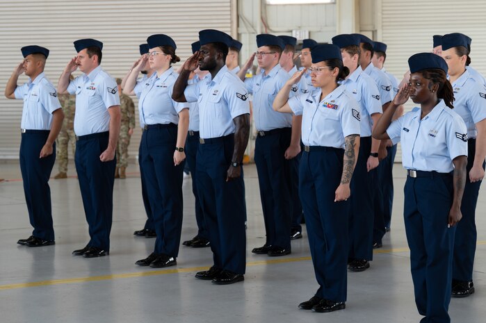 A photo of several Airmen saluting.