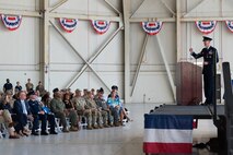 A photo of an Airman speaking to a crowd.
