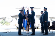 A photo of two Airmen holding a guidon.