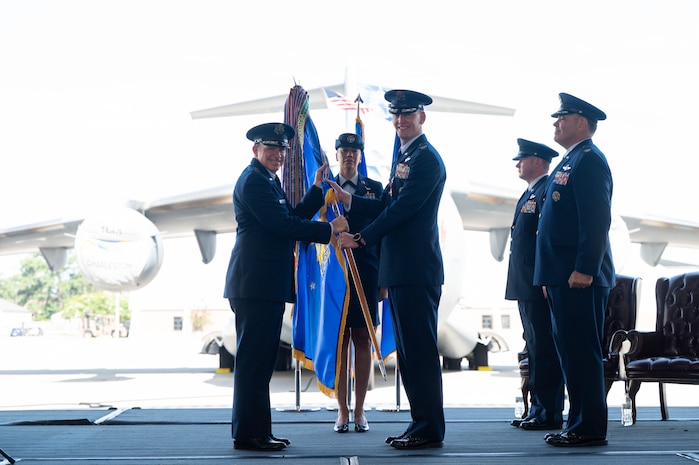 A photo of two Airmen holding a guidon.