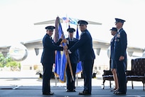 A photo of two Airmen holding a guidon.