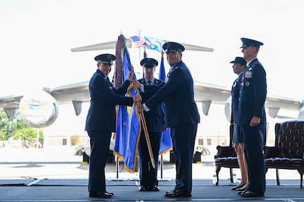 A photo of two Airmen holding a guidon.