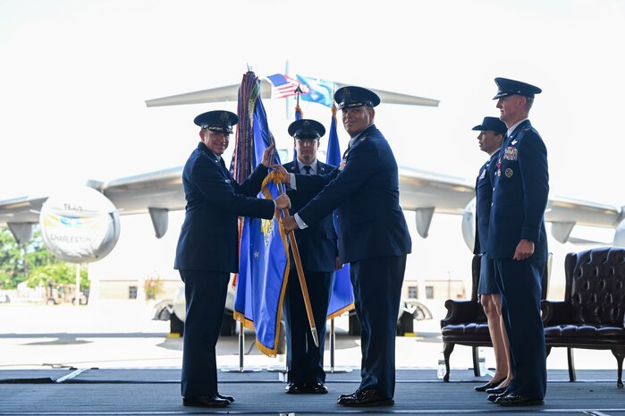 A photo of two Airmen holding a guidon.