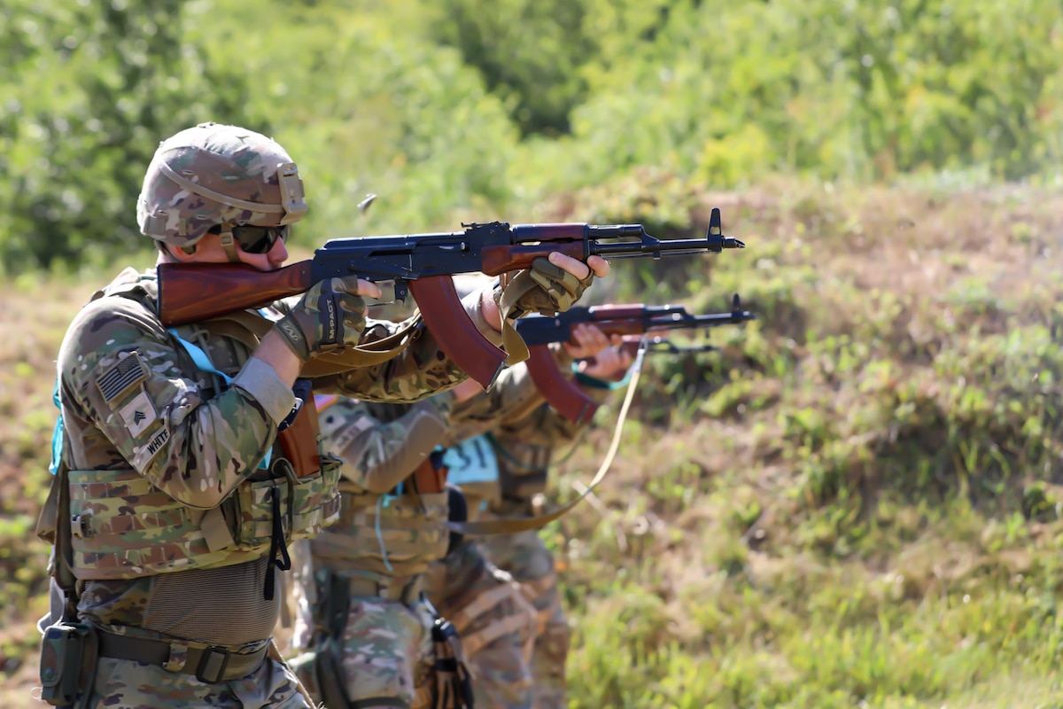Guardsmen fire rifles during the marksmanship portion of the Bulgaria multinational Best Warrior Competition