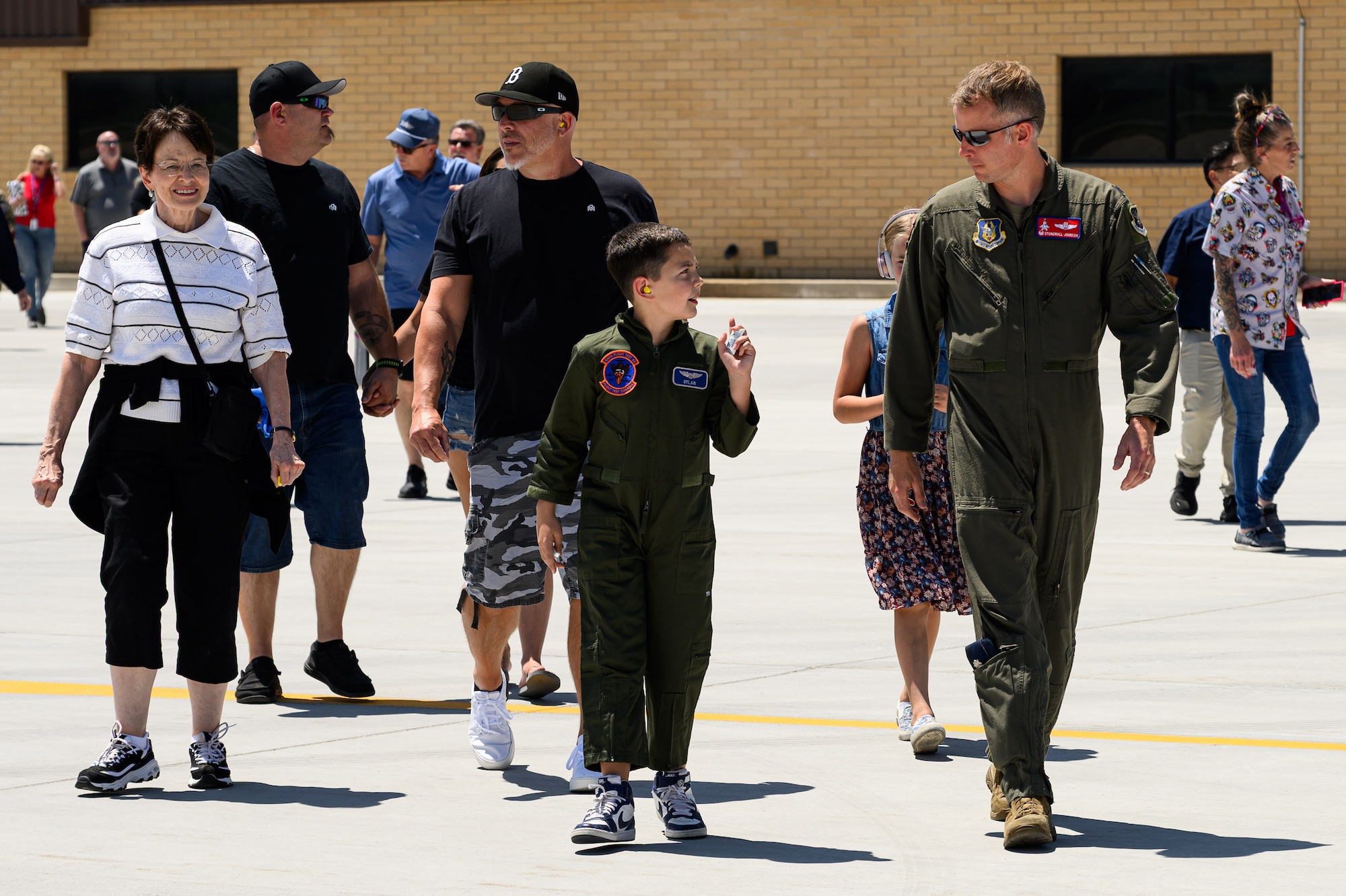 Dylan, Lt. Col. Johnson and guests walking on the airfield ramp.