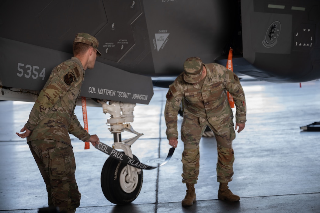 U.S. Air Force Airmen assigned to the 354th Fighter Wing, reveal the incoming commander’s newly painted name on an F-35 Lightning II at Eielson Air Force Base, Alaska, July 2, 2025.