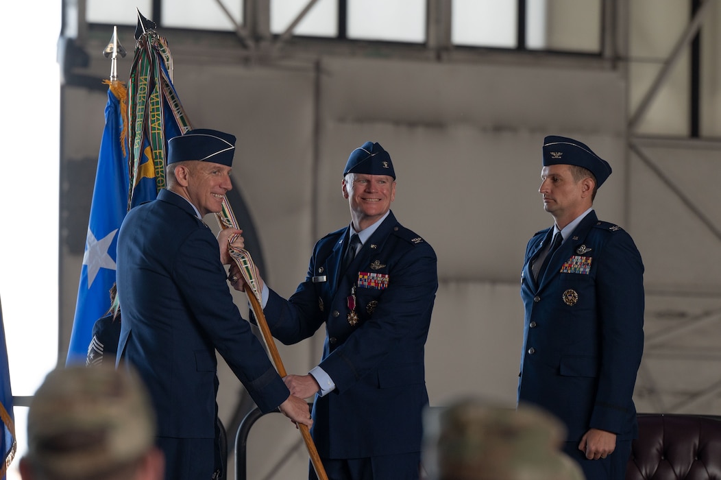 U.S. Air Force Col. Paul Townsend (right), 354th Fighter Wing outgoing commander, relinquishes the guidon to Lt. Gen. Case Cunningham, Alaskan North American Aerospace Defense Command Region, Alaskan Command, and Eleventh Air Force commander, during the 354th FW Change of Command ceremony at Eielson Air Force Base, Alaska, July 2, 2025.