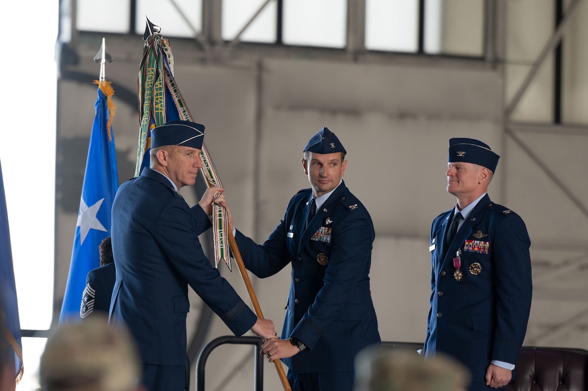 U.S. Air Force Lt. Gen. Case Cunningham, Alaskan North American Aerospace Defense Command Region, Alaskan Command, and Eleventh Air Force commander, passes the guidon to Col. Matthew Johnston, 354th Fighter Wing incoming commander, during the 354th FW Change of Command ceremony at Eielson Air Force Base, Alaska, July 2, 2025.