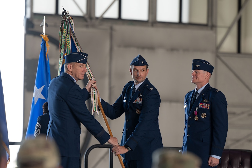 U.S. Air Force Lt. Gen. Case Cunningham, Alaskan North American Aerospace Defense Command Region, Alaskan Command, and Eleventh Air Force commander, passes the guidon to Col. Matthew Johnston, 354th Fighter Wing incoming commander, during the 354th FW Change of Command ceremony at Eielson Air Force Base, Alaska, July 2, 2025.
